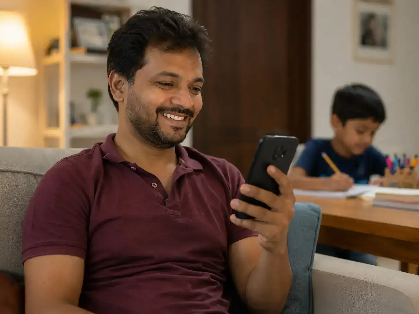Parent reading a WhatsApp fee reminder and exam alert notification from their child's school on a smartphone